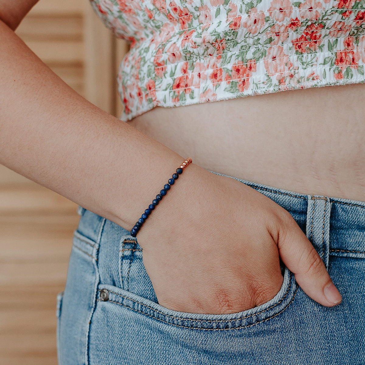 Lapis faceted beaded bracelet bracelet on a wrist with a natural background