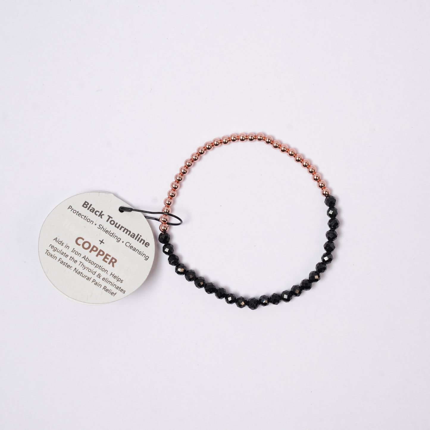 bracelet copper with faceted beads, tag on a background 