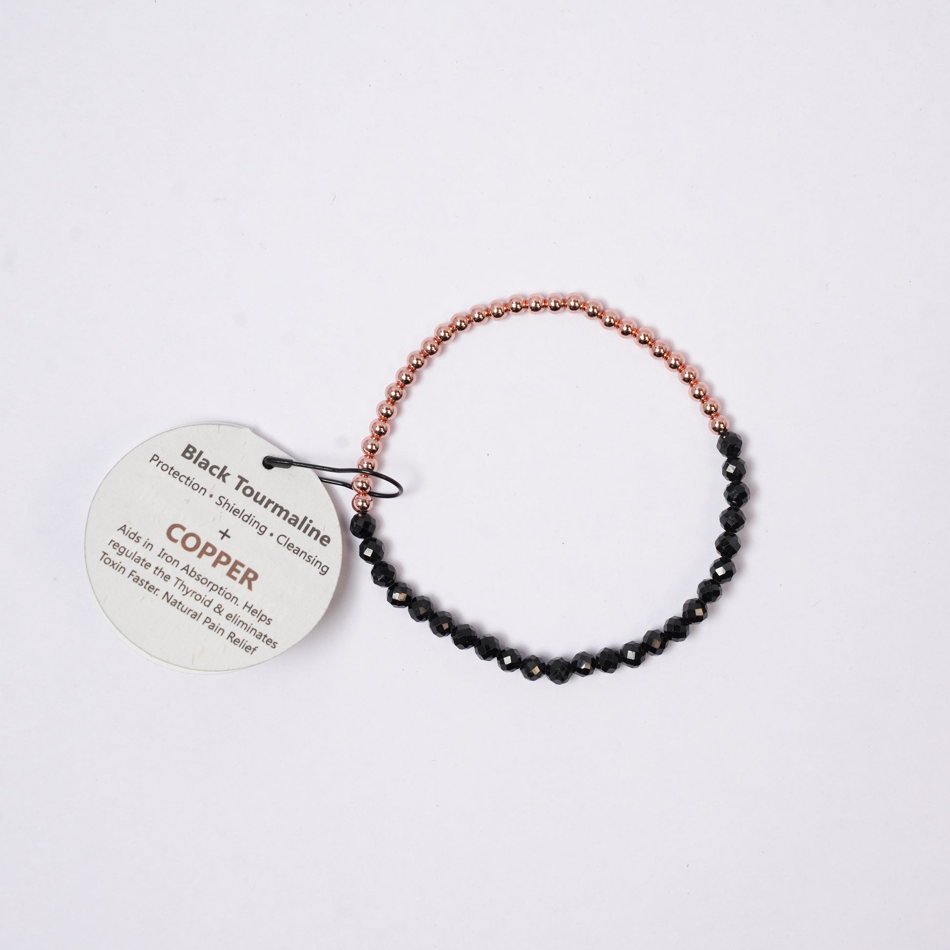 bracelet copper with faceted beads, tag on a background 