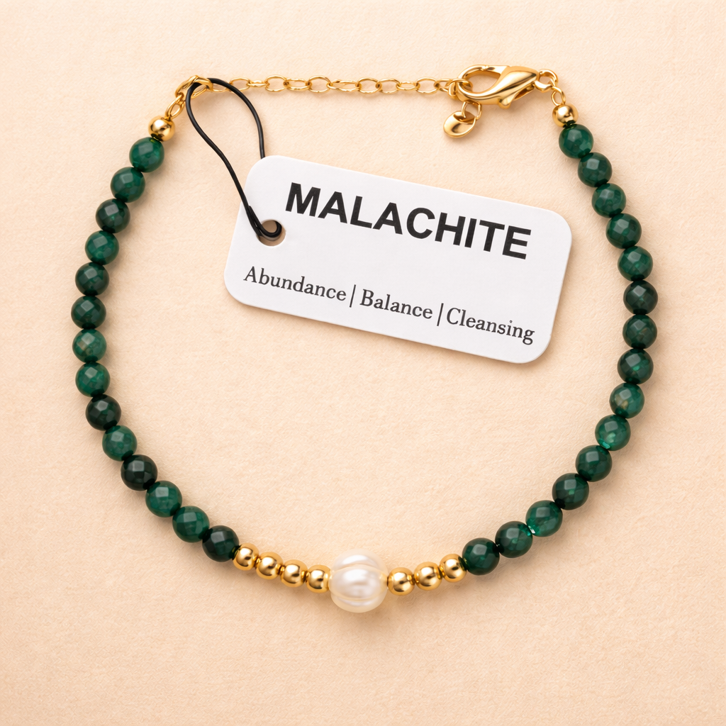 green malachite bead with 'The Blue Yogi' tag on a beige background