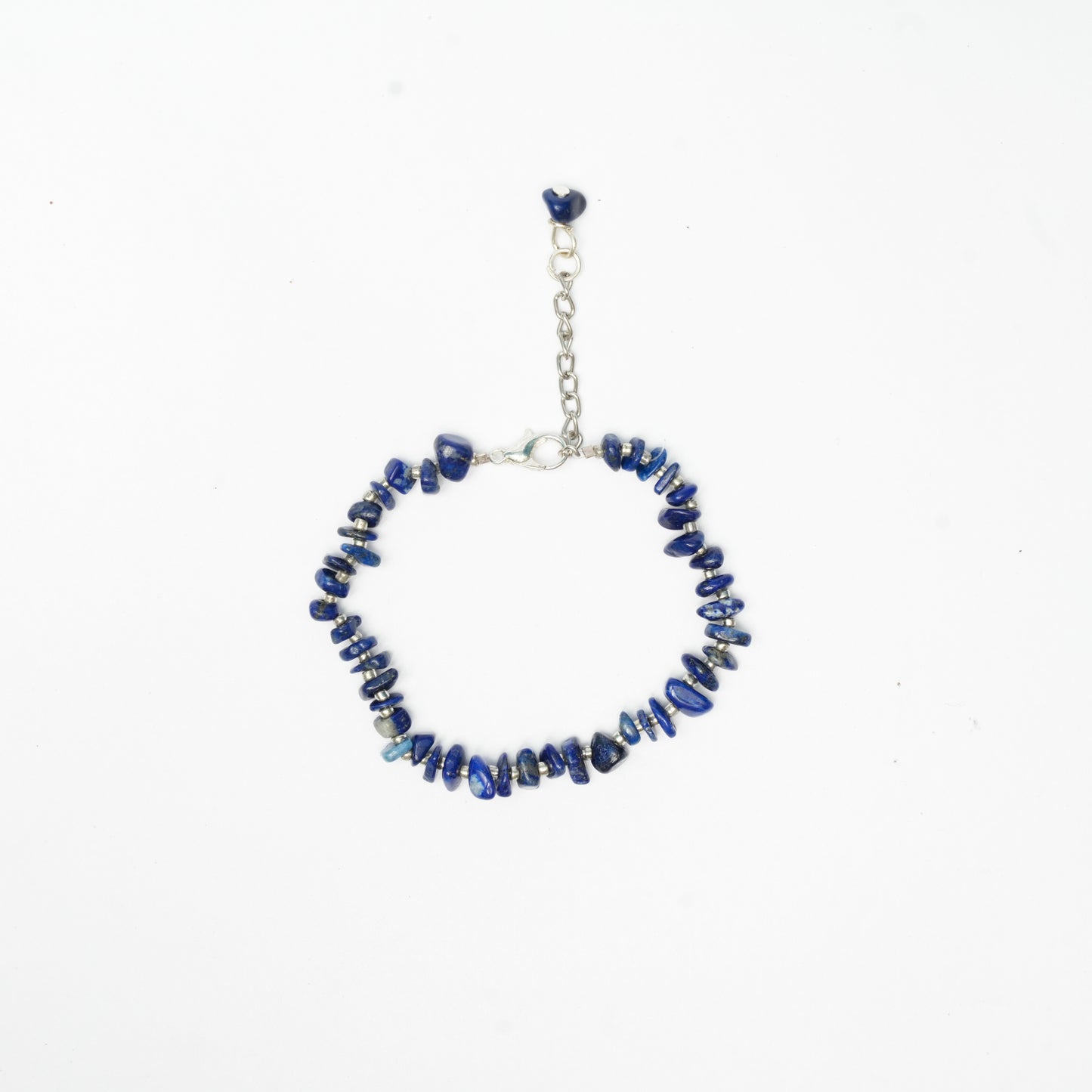Bracelet with black chips, white sugar bead and silver chain on a white background