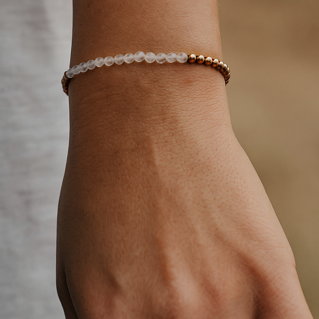 Clear quartz faceted beaded bracelet on a wrist with a natural background