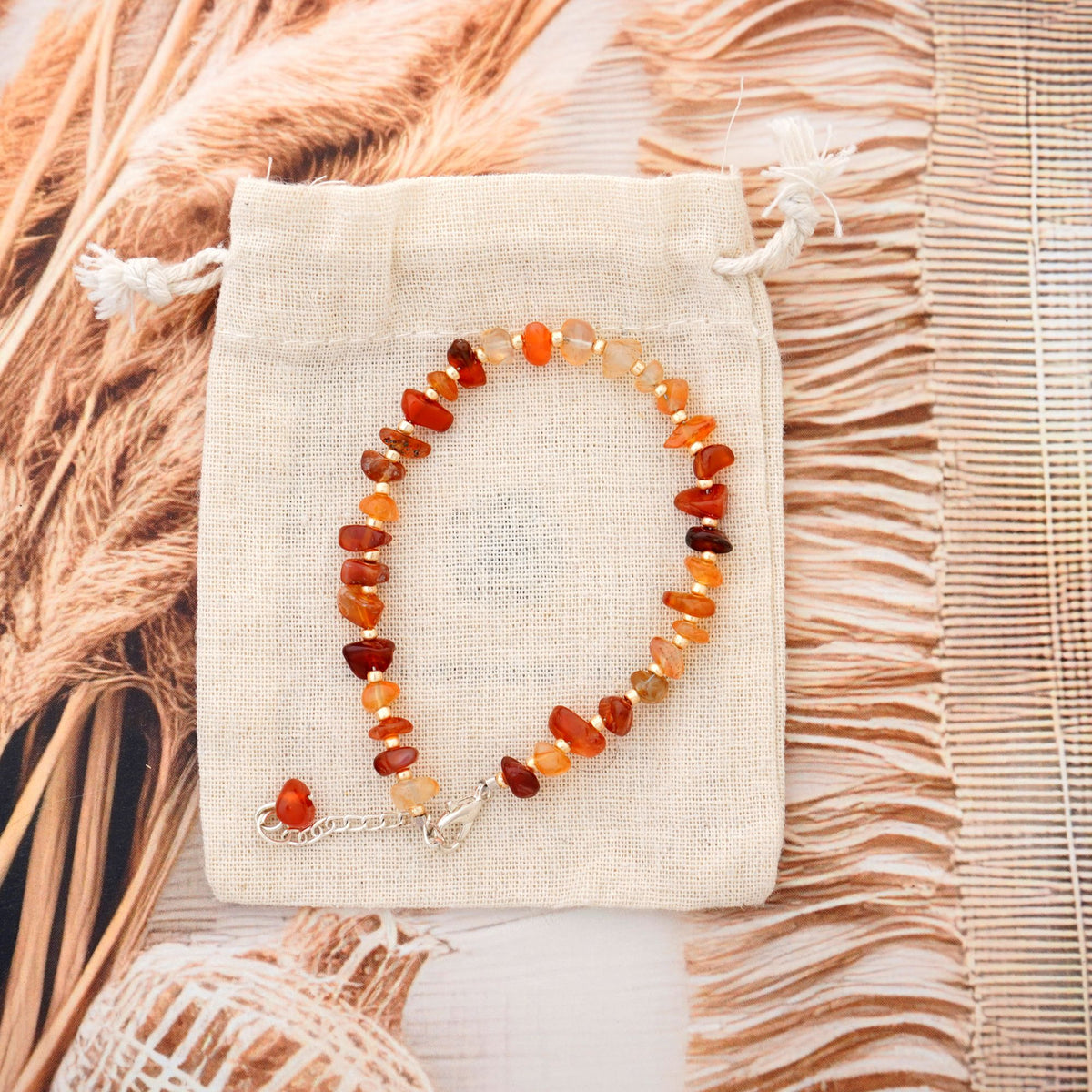 Beaded bracelet on a beige fabric pouch with natural light background