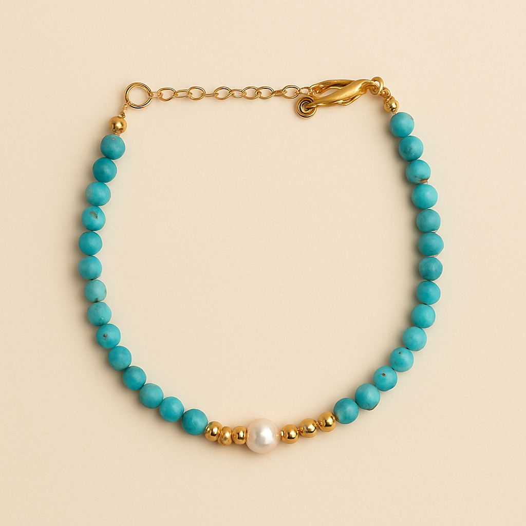 bracelet with blue beads, gold chain, and pearl on a beige background     