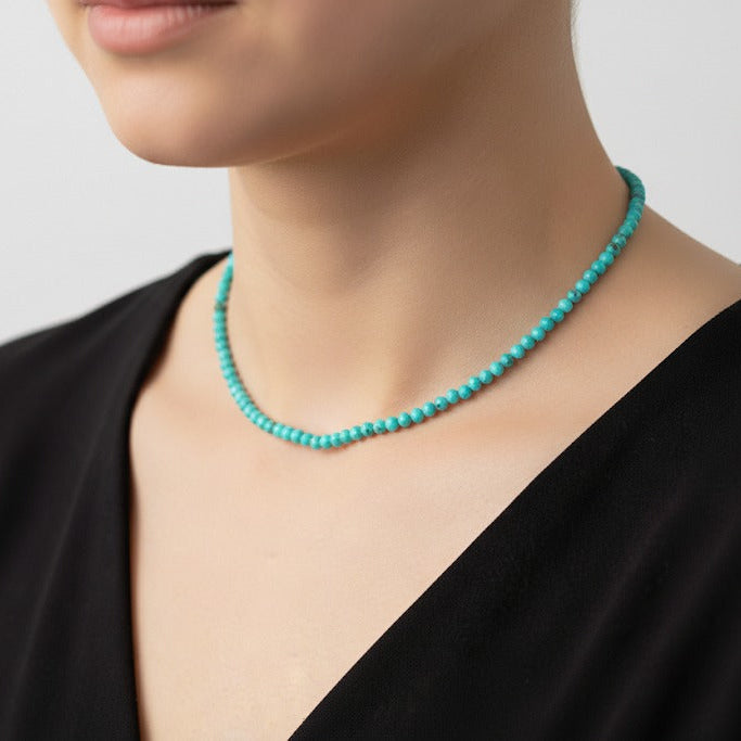 Turquoise beaded necklace worn by a model