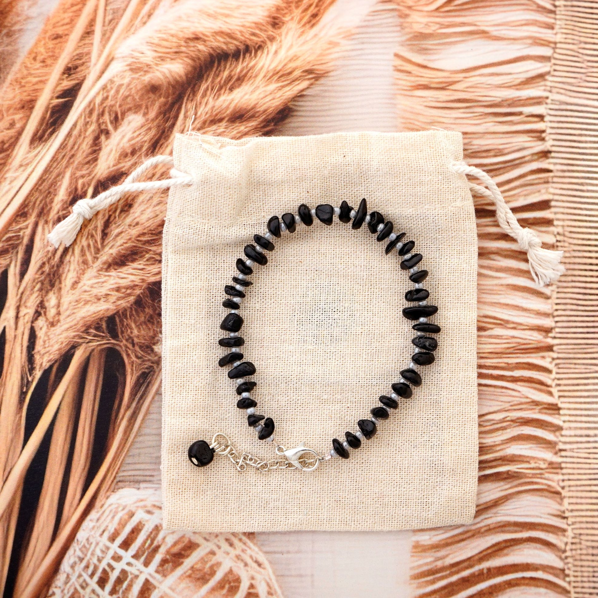 black chips bracelet on a cotton bag with a natural background