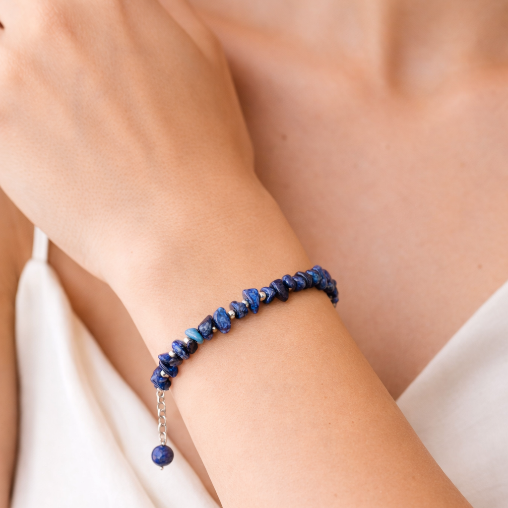 Lapis chip beaded bracelet on a wrist with a natural background