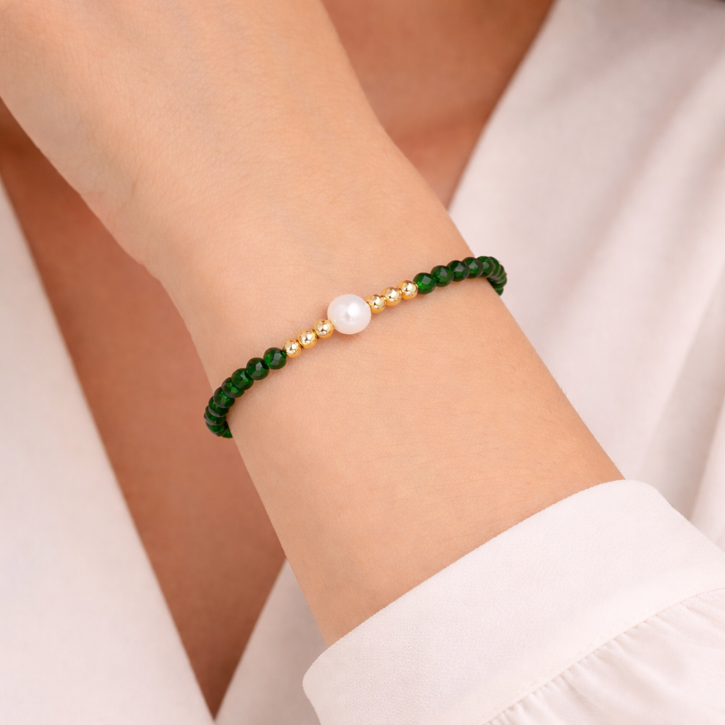 green beaded bracelet on a wrist with a natural background