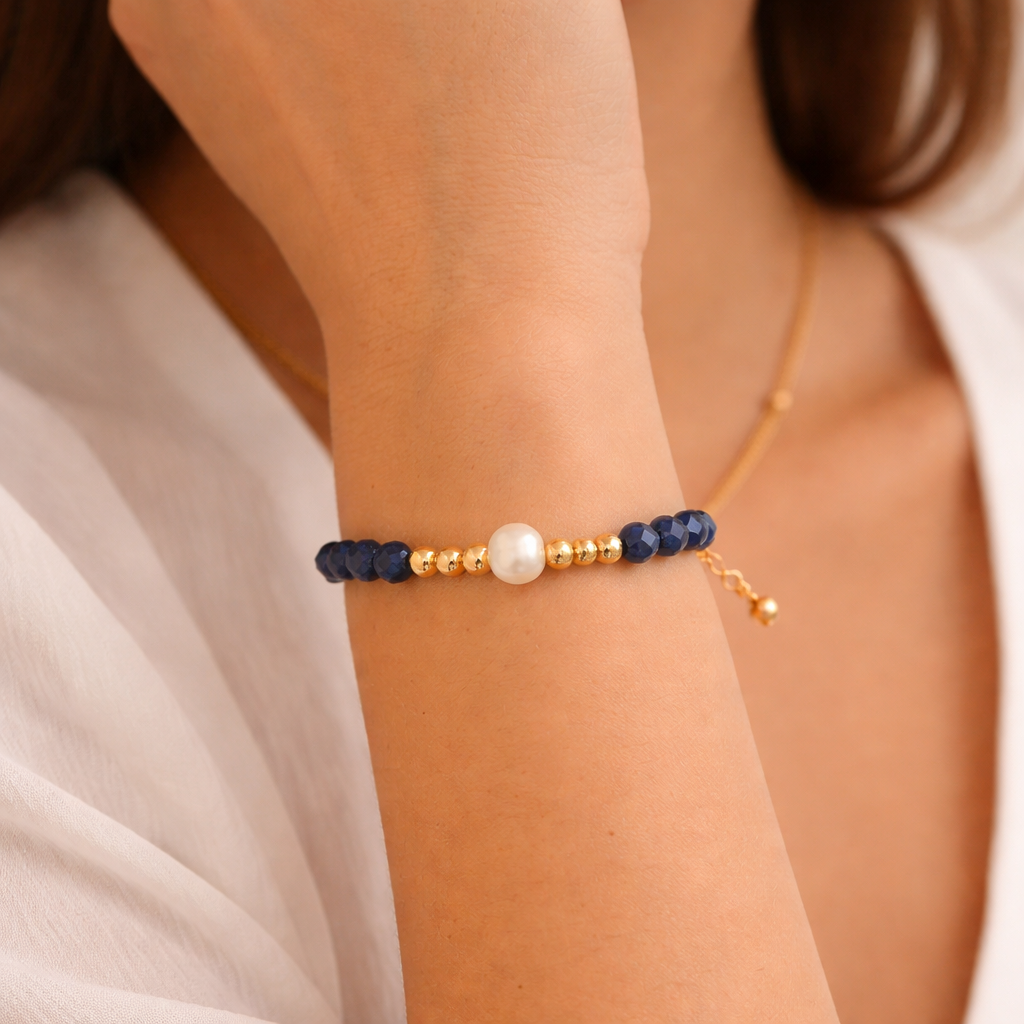 Black beaded bracelet on a wrist with a natural background