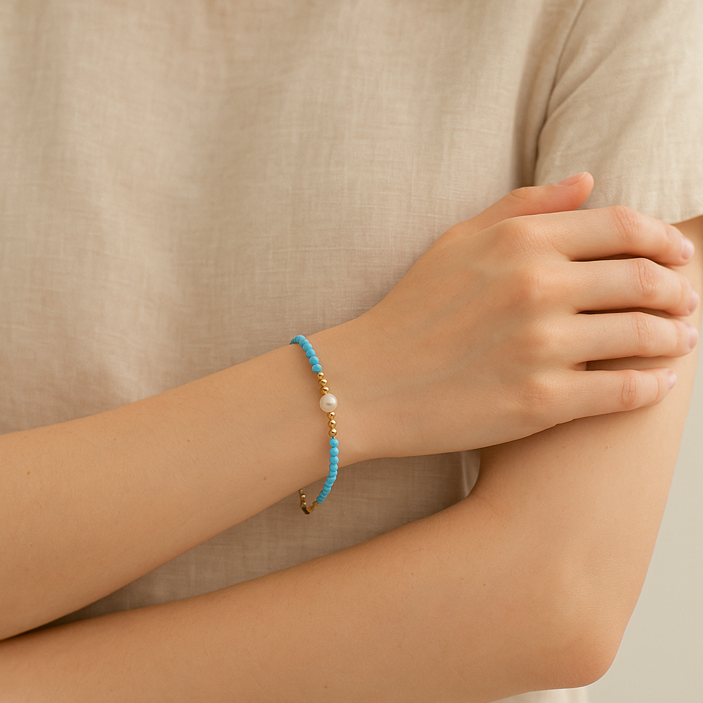 Blue beaded bracelet on a wrist with a natural background