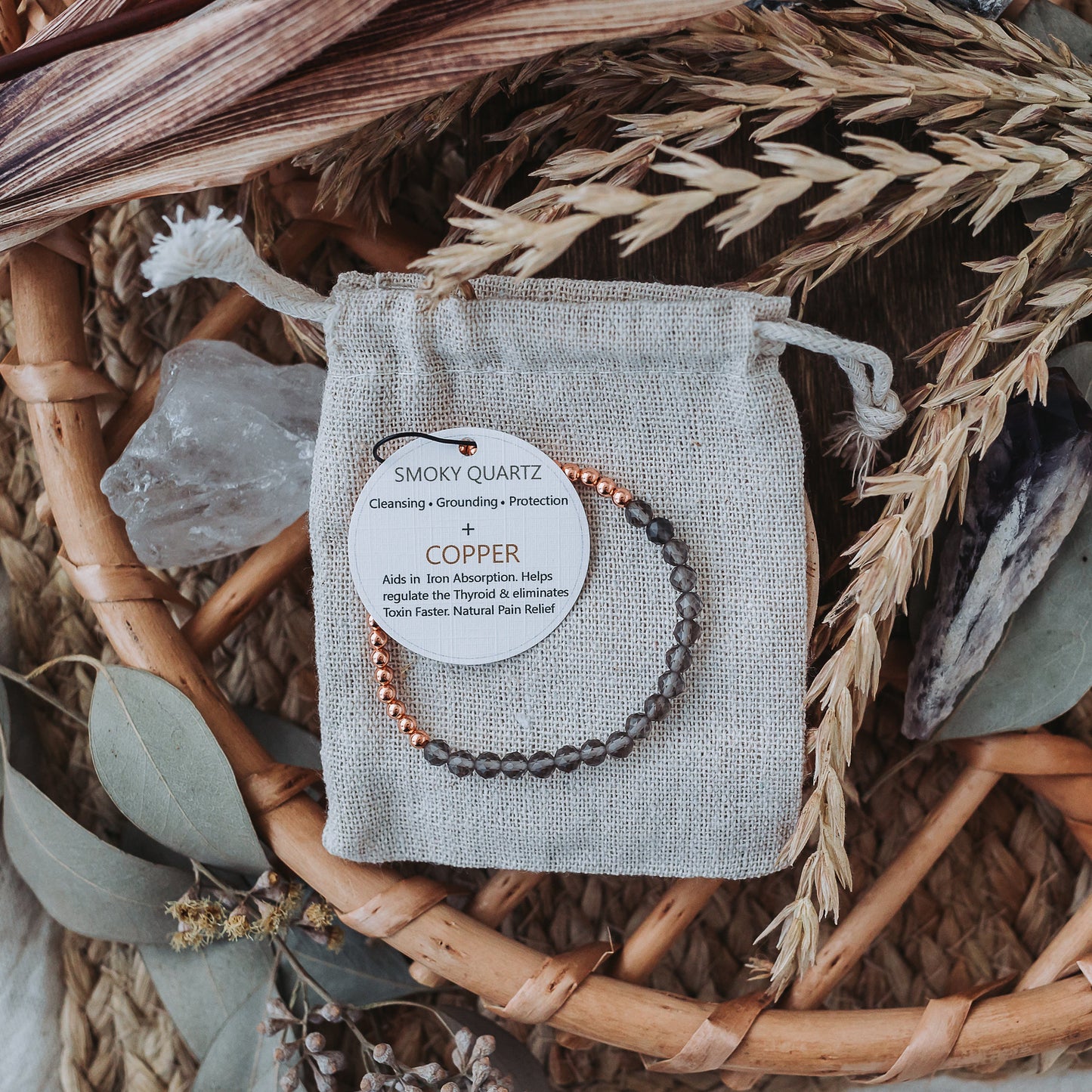 Stretch bracelet with smoky quartz beads, 3mm copper beads and elastic wire on a natural background