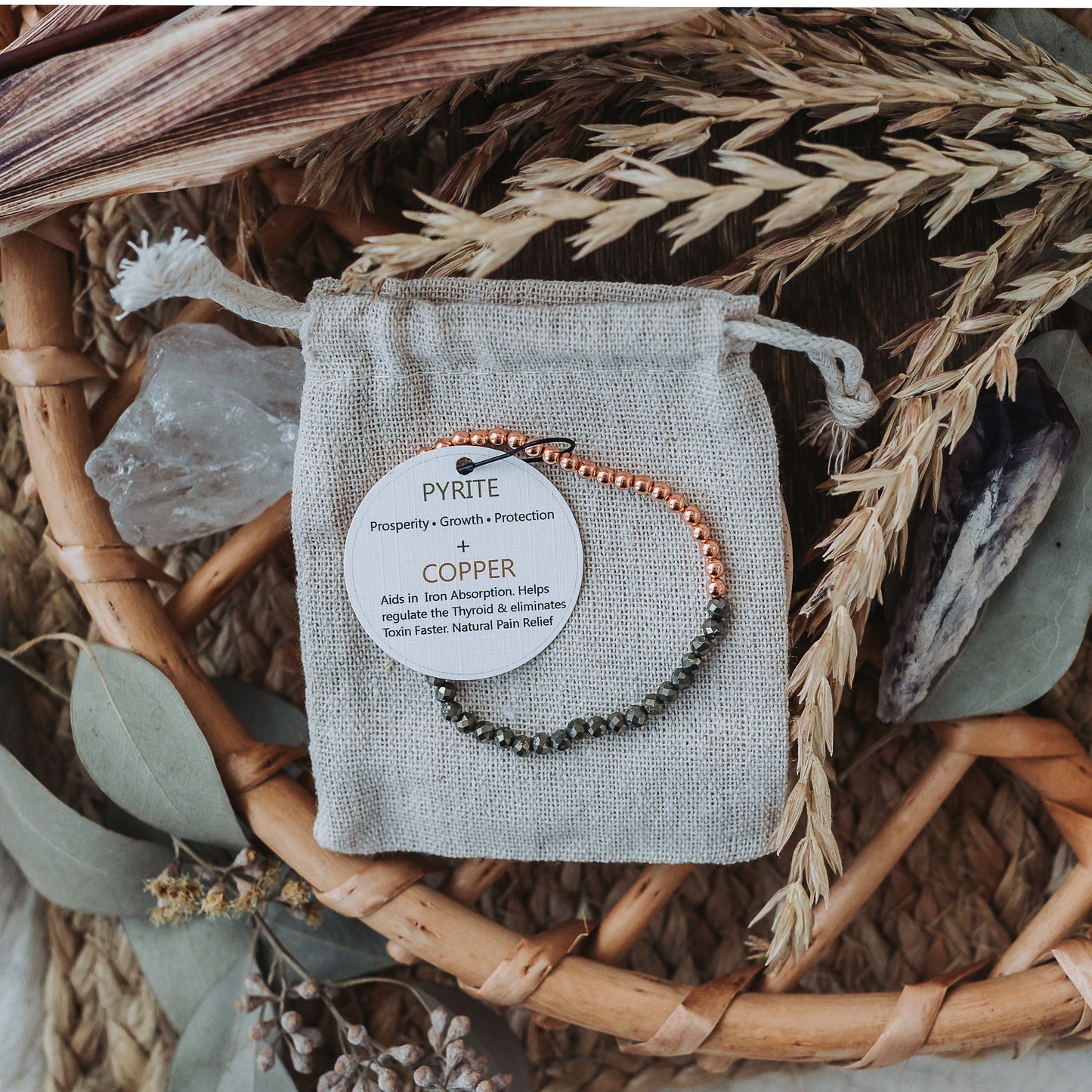 bracelet copper with faceted beads, cotton bag & tag on natural background
